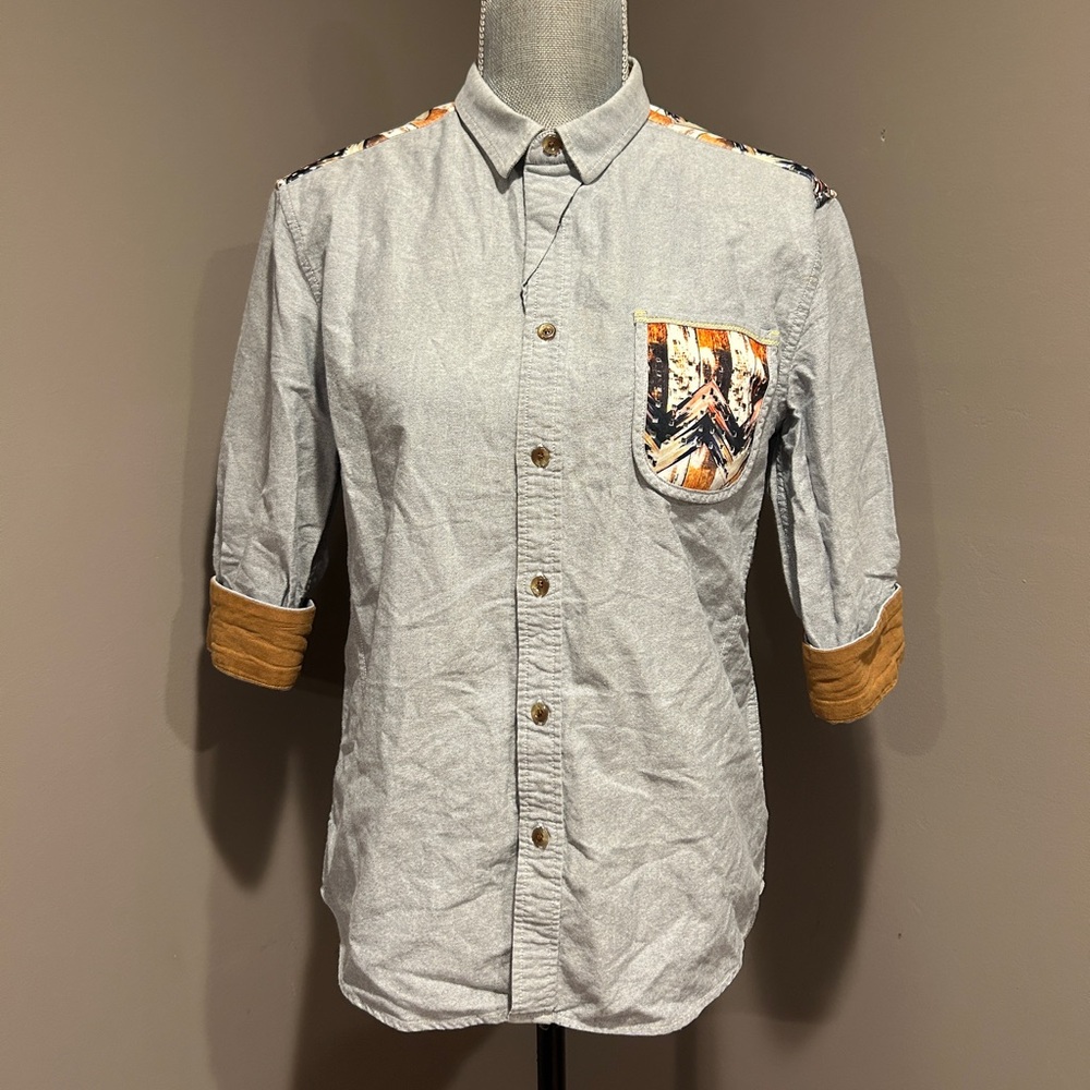 Light gray button up shirt with tan sleeves and pocket